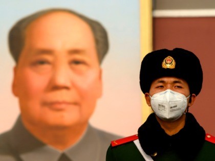A paramilitary police officer wearing a protective facemasks to help stop the spread of a deadly SARS-like virus which originated in the central city of Wuhan, stand on guard in front of the portrait of late communist leader Mao Zedong at Tiananmen Gate in Beijing on January 28, 2020. - …