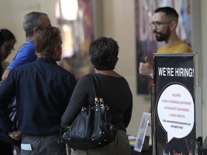 A sign advertises jobs at Neiman Marcus Last Call during a job fair at Dolphin Mall, Tuesday, Oct. 1, 2019, in Miami. (AP Photo/Lynne Sladky)
