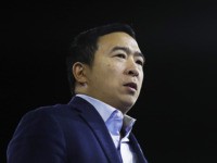 Democratic presidential candidate businessman Andrew Yang passes as he speaks at the McIntyre-Shaheen 100 Club Dinner, Saturday, Feb. 8, 2020, in Manchester, N.H. (AP Photo/Matt Rourke)