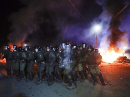 Ukrainian riot police prepare to push back protesters, who planned to stop buses carrying