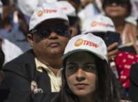 Spectators wear Trump hats as President Donald Trump and Indian Prime Minister Narendra Modi speak during a “Namaste Trump,” event at Sardar Patel Gujarat Stadium, Monday, Feb. 24, 2020, in Ahmedabad, India. (AP Photo/Alex Brandon)