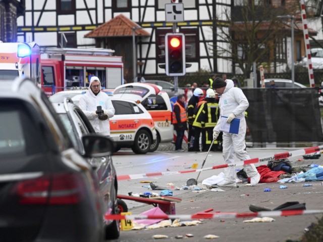Police and rescue workers stand next to the scene of the accident with a car that is said to have crashed into a carnival parade in Volkmarsen, central Germany, Monday, Feb. 24, 2020. Several people have been injured, according to the police. The driver had been arrested by the police. …