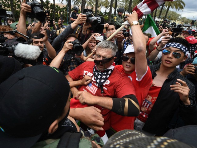 Anti-Trump protesters (L) clash with Donald Trump supporters (C) outside the Anaheim Convention Center during a rally for Republican presidential candidate Donald Trump on May 25, 2016 in Anaheim, California. Police were on high alert one day after violence marred a Trump rally in the southwestern state of New Mexico, …