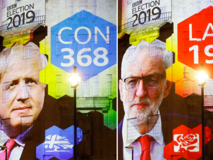 TOPSHOT - The broadcaster's exit poll results projected on the outside of the BBC building in London shows Britain's Prime Minister Boris Johnson's Conservative Party predicted to win 368 seats and a majority (L) and Jeremy Corbyn's opposition Labour Party to win 191 seats, as the ballots begin to be …