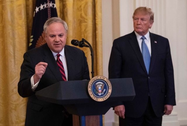US President Donald Trump listens as Interior Secretary David Bernhardt speaks about the administration's environmental policies at the White House in Washington, DC on July 8, 2019. (Photo by NICHOLAS KAMM / AFP) (Photo credit should read NICHOLAS KAMM/AFP via Getty Images)