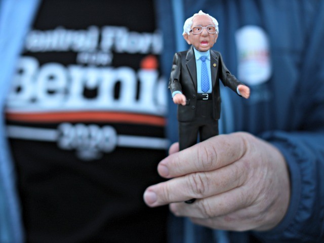 DES MOINES, - FEBRUARY 02: A supporter holds a Bernie action figure outside a campaign eve