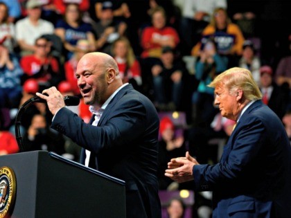 US President Donald Trump (R) claps as Ultimate Fighting Championship (UFC) President Dana