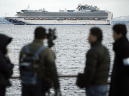 A TV crew film a cruise ship Diamond Princess anchoring off the Yokohama Port Tuesday, Feb. 4, 2020, in Yokohama, near Tokyo. Japanese health officials are conducting extensive medical checks on all 3,700 passengers and crew of the cruise ship that returned to the country after one passenger tested positive …