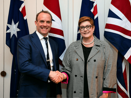 Australia's Foreign Minister Marise Payne (R) shakes hands with Britain's Foreign Secretary Dominic Raab (L) prior to their bilateral meeting at Parliament House in Canberra on February 6, 2020. - Raab is on a two-day official visit to hold talks on bilateral issues with Australian officials. (Photo by LUKAS COCH …