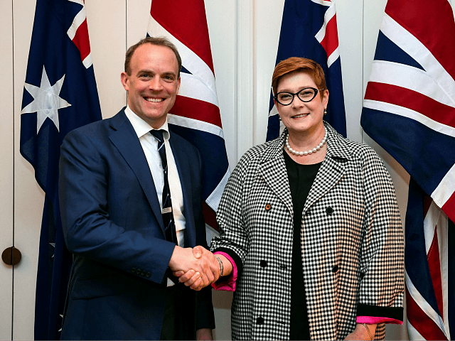Australia's Foreign Minister Marise Payne (R) shakes hands with Britain's Foreign Secretar