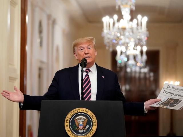 U.S. President Donald Trump holds a copy of The Washington Post as he speaks in the East Room of the White House one day after the U.S. Senate acquitted on two articles of impeachment, ion February 6, 2020 in Washington, DC. After five months of congressional hearings and investigations about …