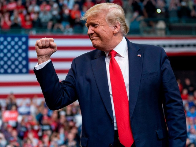 US President Donald Trump gestures as he arrives to speak during a rally in Manchester, Ne