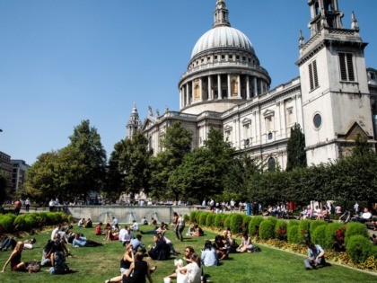 LONDON, ENGLAND - AUGUST 06: City workers eat their lunches in front of St Paul's Cat