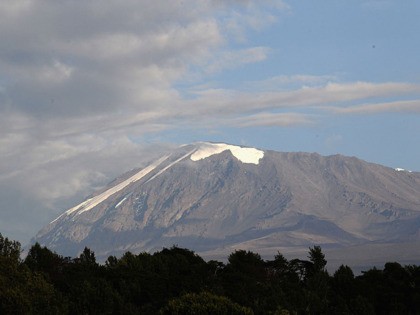 ARUSHA, TANZANIA - DECEMBER 06: Snow covers the top of Kilimanjaro on day one of the Marti