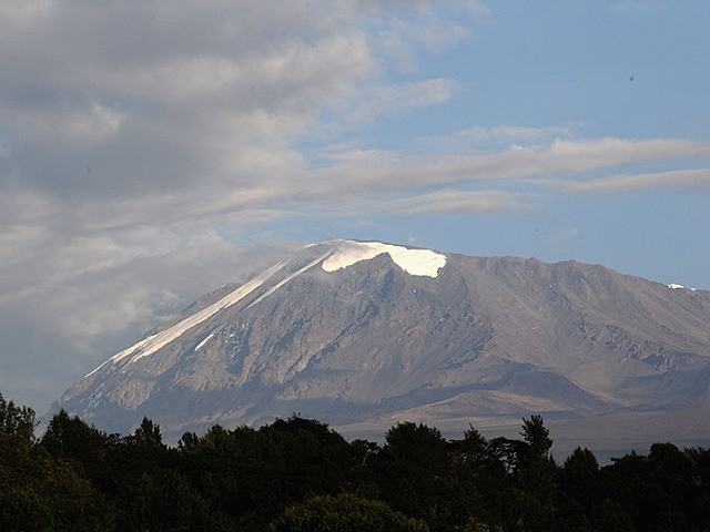 ARUSHA, TANZANIA - DECEMBER 06: Snow covers the top of Kilimanjaro on day one of the Martina Navratilova Mt. Kilimanjaro Climb on December 6, 2010 in Arusha, Tanzania. Martina Navratilova and her team are climbing Mount Kilimanjaro to raise money for the Laureus Sport for Good Foundation. Martina Navratilova, a …