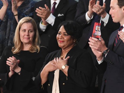 Alice Johnson (C), one of the US President's special guests, reacts as the president acknowledges her during his State of the Union address at the US Capitol in Washington, DC, on February 5, 2019. (Photo by SAUL LOEB / AFP) (Photo credit should read SAUL LOEB/AFP via Getty Images)