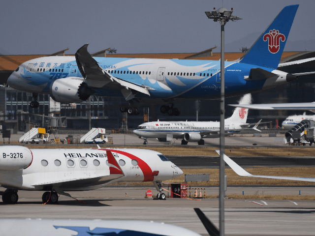 An Air China Boeing 737 MAX 8 plane is seen (back C) as a China Southern Airlines Boeing 787 (top) lands at Beijing Capital Airport on March 11, 2019. - China on March 11, 2019 ordered domestic airlines to suspend commercial operation of the Boeing 737 MAX 8, citing the …