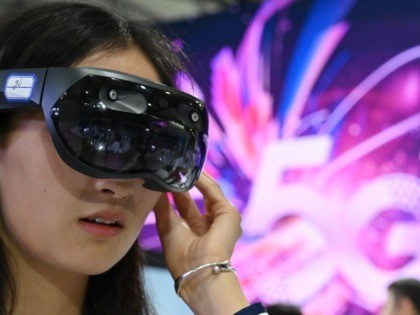 A woman tries out a Huawei augmented reality headset during the Mobile World Congress (MWC