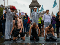 LONDON, ENGLAND - OCTOBER 12: Extinction Rebellion activists pour fake oil over each other as they continue to demonstrate for the sixth day running in Trafalgar Square on October 12, 2019 in London, England. The climate change activists have blockaded various central locations around Westminster and police continue to arrest …