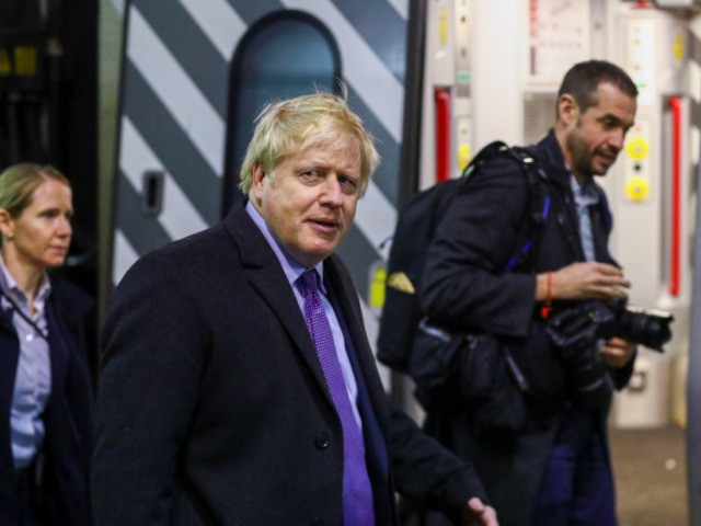 MILTON KEYNES, UNITED KINGDOM - DECEMBER 4: Britain's Prime Minister Boris Johnson walks along the platform at Euston train station after an election campaign visit to Red Bull Racing on December 4, 2019 in Milton Keynes, England. The UK will go to the polls on December 12, the third General …