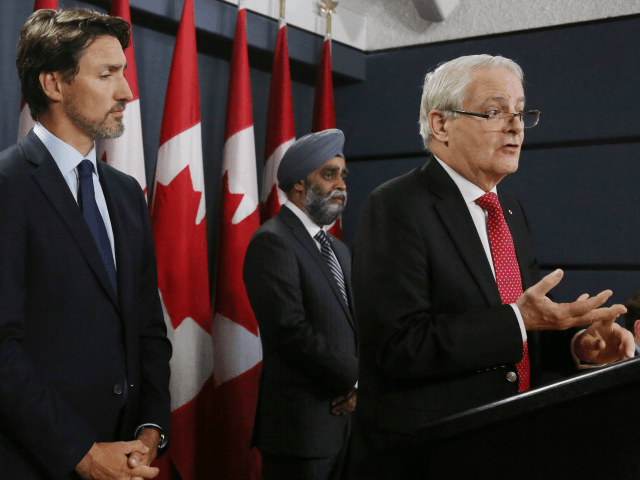 Canadian Prime Minister Justin Trudeau (L), Minister of National Denfence Harjit Sajjan (C) listen as Minister of Transportation Marc Garneau addresses the media during a news conference January 8, 2020 in Ottawa, Canada. (Photo by Dave Chan / AFP) (Photo by DAVE CHAN/AFP via Getty Images)