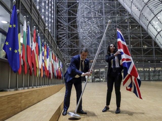 TOPSHOT - EU Council staff members remove the United Kingdom's flag from the European Council building in Brussels on Brexit Day, January 31, 2020. - Britain leaves the European Union at 2300 GMT on January 31, 2020, 43 months after the country voted in a June 2016 referendum to leave …