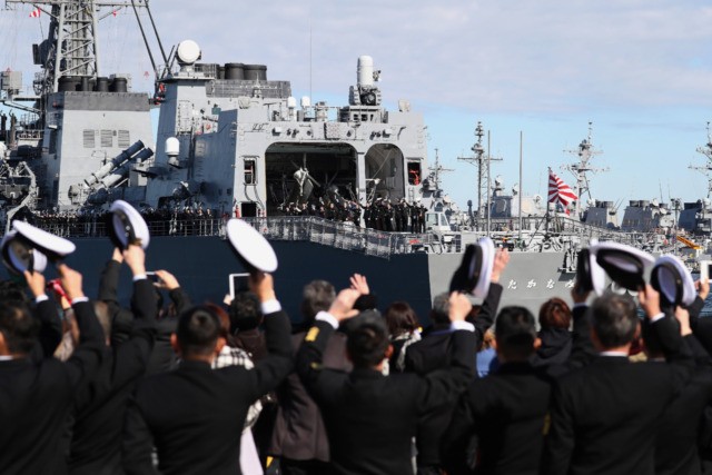 People wave as Japan's Maritime Self-Defence Force destroyer "Takanami" leaves for the Middle East at Yokosuka Naval Base in Yokosuka, Kanagawa prefecture on February 2, 2020. - Japan dispatched the naval destroyer to Middle East for a rare overseas mission to ensure safety of Japanese ships amid lingering tension between …