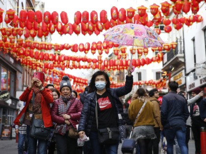 LONDON, ENGLAND - FEBRUARY 02: A woman wears a face mask in Chinatown on February 2, 2020 in London, England. There are currently 2 confirmed cases of Coronavirus in the UK.(Photo by Hollie Adams/Getty Images)