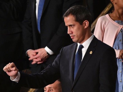 Venezuelan opposition leader Juan Guaido (C) pumps his fist as he is acknowledged by US Pr