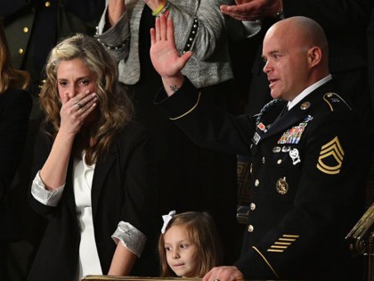 Sgt Townsend Williams (R) waves alongside his daughter and his wife Amy (L) after returnin