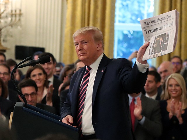 WASHINGTON, DC - FEBRUARY 06: U.S. President Donald Trump holds up a newspaper as he speak