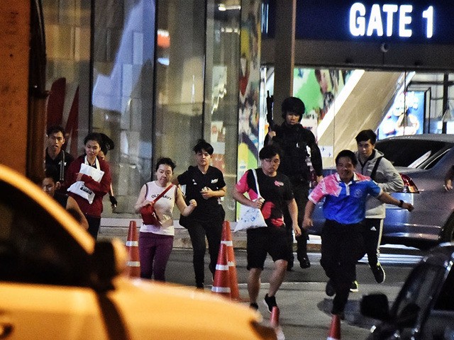 People run together as they are rescued by Thai commandos from Terminal 21 shopping mall,