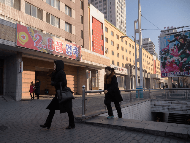 In a photo taken on February 8, 2020 people walk on a street in Pyongyang. (Photo by KIM W