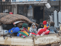 Syrians drive with their belongings as they flee the town of Atme in Syria's northwestern Idlib province, near the Turkish border, on February 12, 2020, following a weeks-long regime offensive against the country's last major rebel bastion. (Photo by Rami al SAYED / AFP) (Photo by RAMI AL SAYED/AFP via …