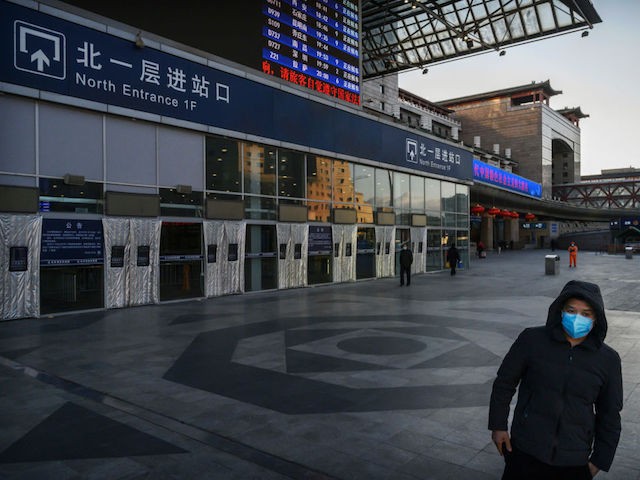 BEIJING, CHINA - FEBRUARY 16: A Chinese man wears a protective mask as he stands outside a main entrance at Beijing West Railway Station as it is nearly empty on February 16, 2020 in Beijing, China. The number of cases of the deadly new coronavirus COVID-19 rose to more than 57000 in mainland China Sunday, in what the World Health Organization (WHO) has declared a global public health emergency. China continued to lock down the city of Wuhan in an effort to contain the spread of the pneumonia-like disease which medicals experts have confirmed can be passed from human to human. In an unprecedented move, Chinese authorities have maintained and in some cases tightened the travel restrictions on the city which is the epicentre of the virus and also in municipalities in other parts of the country affecting tens of millions of people. The number of those who have died from the virus in China climbed to over 1650 on Sunday, mostly in Hubei province, and cases have been reported in other countries including the United States, Canada, Australia, Japan, South Korea, India, the United Kingdom, Germany, France and several others. The World Health Organization has warned all governments to be on alert and screening has been stepped up at airports around the world. Some countries, including the United States, have put restrictions on Chinese travellers entering and advised their citizens against travel to China. (Photo by Kevin Frayer/Getty Images)