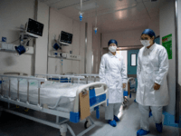 Nurses walk inside a quarantine room at the finished but still unused building A2 of the Shanghai Public Clinical Center, where COVID-19 coronavirus patients will be quarantined, in Shanghai on February 17, 2020. - The death toll from the COVID-19 coronavirus epidemic jumped to 1,770 in China after 105 more …