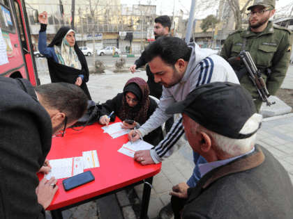 An Iranian man registers to vote at a mobile polling station in the capital Tehran on February 21, 2020. - Electoral authorities in Iran extended voting for two hours in the Islamic republic's parliamentary election on Friday, state television reported. (Photo by ATTA KENARE / AFP) (Photo by ATTA KENARE/AFP …