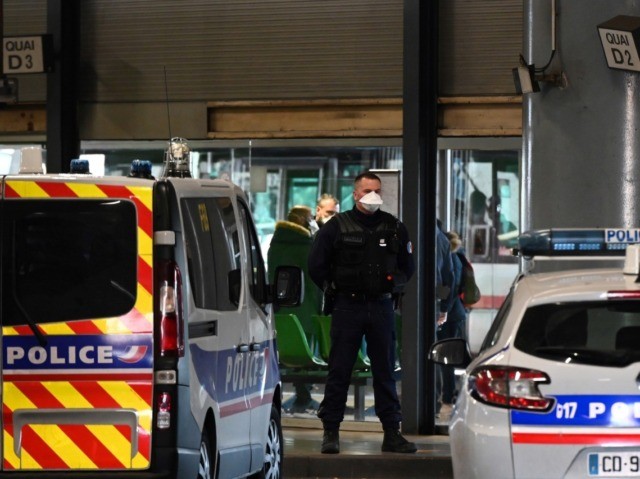 A police officer stands guard at the train and bus station Lyon Perrache after marking a