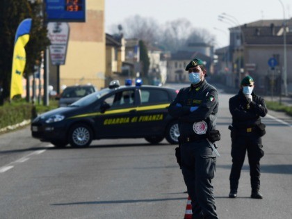 Italian Finance guards (Guardia di Finanza) officers patrol by a check-point at the entrance of the small town of Zorlesco, southeast of Milan, on February 24, 2020, situated in the red zone of the COVID-19 the novel coronavirus outbreak in northern Italy. - Italy, the country with the most confirmed …