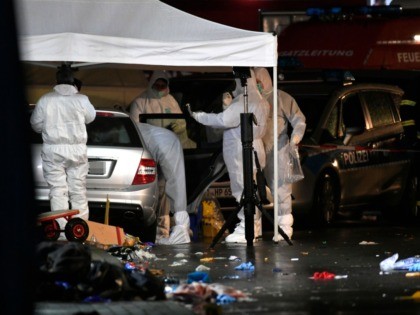 Police officers investigate the car of the man who drove into a carnival procession on Feb