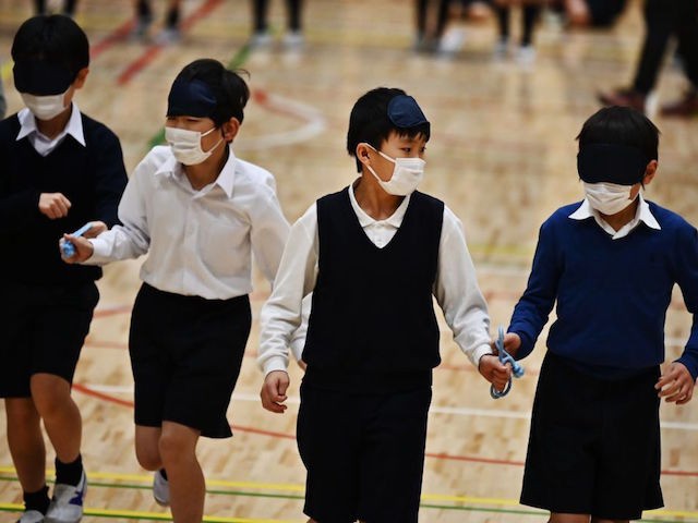 Pupils of the Ariake-nishi Gakuen elementary school take part in an exercise led by para-athlete Chiaki Takada (not in picture) during an event marking six months till the Tokyo 2020 Paralympic Games in Tokyo on February 25, 2020. (Photo by CHARLY TRIBALLEAU / AFP) (Photo by CHARLY TRIBALLEAU/AFP via Getty …
