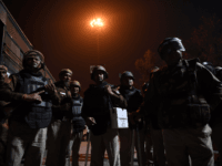 Police guard a street in an area following clashes between supporters and opponents of a new citizenship law in New Delhi on February 25, 2020. - Ten people were killed and more than 130 injured in some of the worst sectarian violence in India's capital in years, as rioters went …
