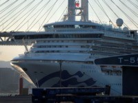 The Diamond Princess cruise ship is seen at the Daikoku Pier Cruise Terminal in Yokohama port on February 27, 2020. - Crew members from a coronavirus-stricken cruise ship off Japan began leaving the vessel February 27 for a new quarantine on-shore after passengers left the boat, the government said, as …