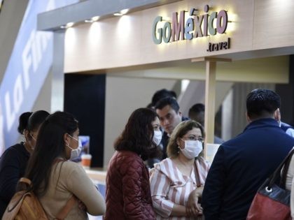 Passengers wearing protective masks are seen at the International Airport in Mexico City, on February 28, 2020. - Mexico's Health Ministry confirmed the country's first case of coronavirus on Friday, saying a young man had tested positive for it in the capital. (Photo by ALFREDO ESTRELLA / AFP)