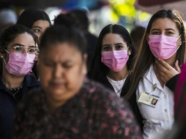 People walking in the streets of Culiacan, Sinaloa state, wear protective face masks on Fe