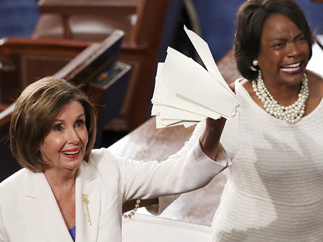 WASHINGTON, DC - FEBRUARY 04: House Speaker Rep. Nancy Pelosi (D-CA) (L) holds up the ripped up copy of President Donald Trump's speech after the State of the Union address in the chamber of the U.S. House of Representatives on February 04, 2020 in Washington, DC. President Trump delivers his …