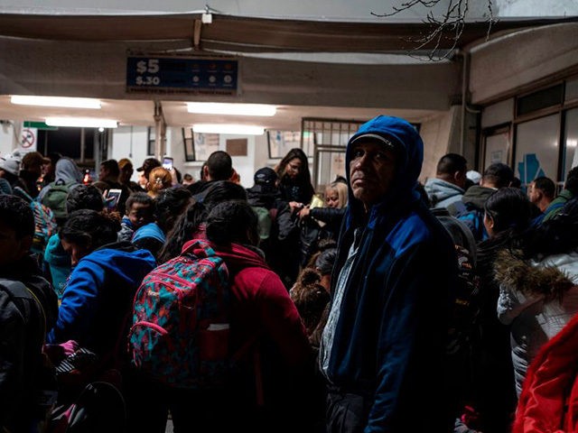 Migrants part of the Remain in Mexico policy wait at the entrance to the Paso del Norte International Bridge on February 28, 2020, in Ciudad Juárez. - Migrant Protection Protocols, better known as the Remain in Mexico Policy was blocked by the United States Court of Appeals for the Ninth …