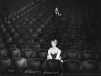 circa 1955: French actor Brigitte Bardot sits in a nearly empty movie theater. (Photo by Hulton Archive/Getty Images)