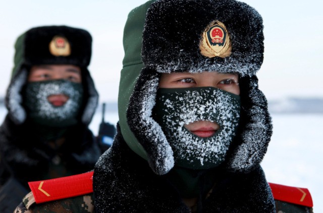 TOPSHOT - Chinese paramilitary police border guards train in the snow at Mohe County in China's northeast Heilongjiang province, on the border with Russia, on December 12, 2016. Mohe is the northernmost point in China, with a sub arctic climate where border guards operate in temperatures as low as -36 …