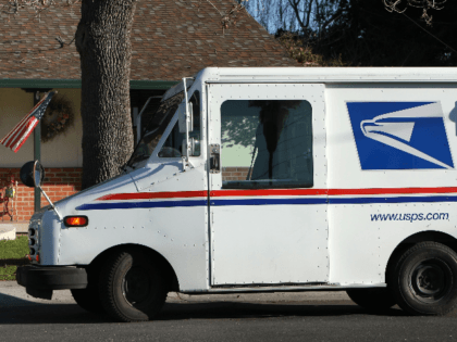 US Postal Service letter carrier Dennis Stecz walks back to his truck after delivering a p